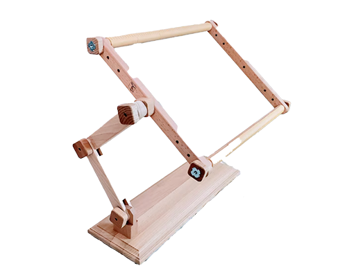 A wooden embroidery lap frame and floor stand for needlepoint stitching
