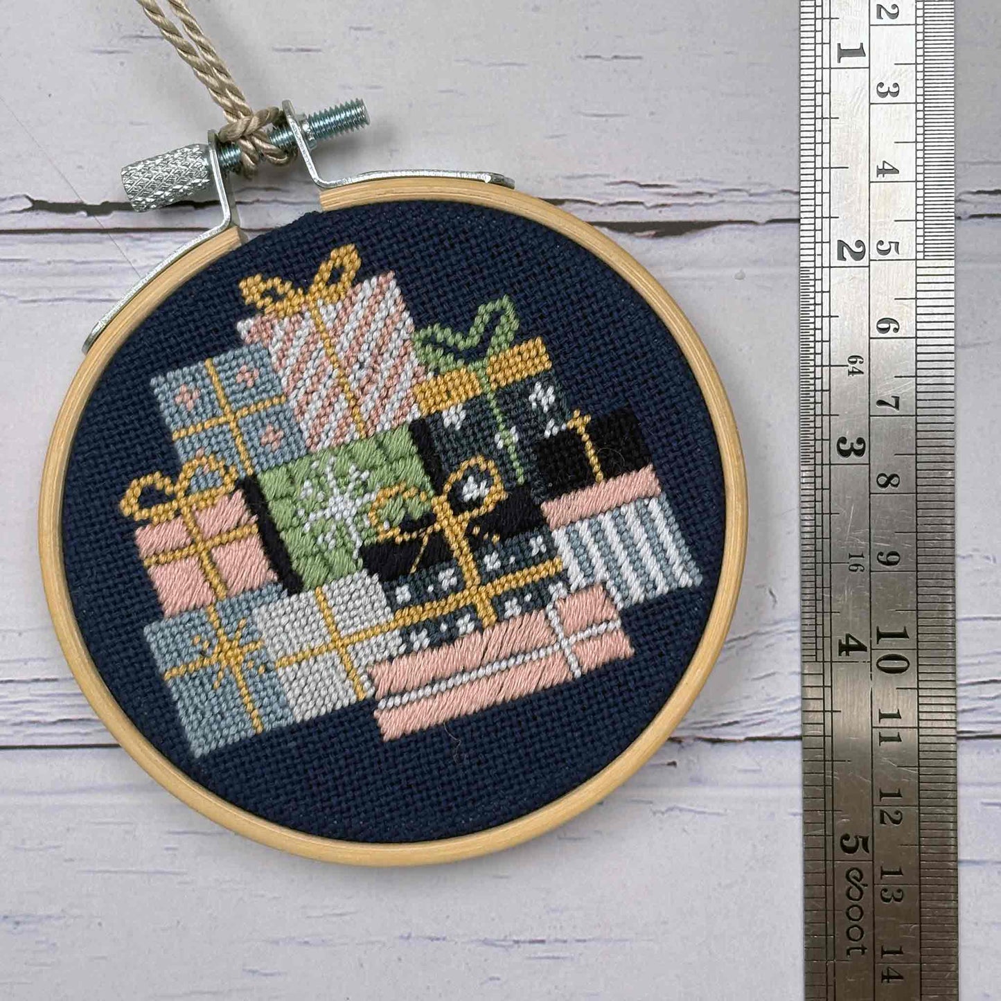 Festive Gifts Needlepoint kit completed with ruler to illustrate scale